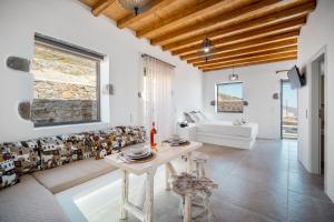 a living room with a table and a couch at Petrias Pool House in Serifos Chora