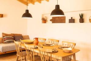 a dining room with a wooden table and chairs at Vida na Aldeia in São Luis
