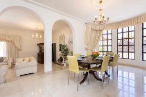 a dining room and living room with a table and chairs at Villa Las Flores in Acantilado de los Gigantes