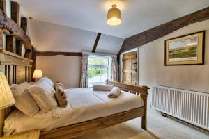 a bedroom with a bed and a window at Ashfield Place Farm by Group Retreats in Stowmarket +47 photos