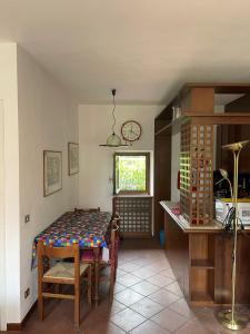 a dining room with a table in a kitchen at Lakeside holiday in Salò