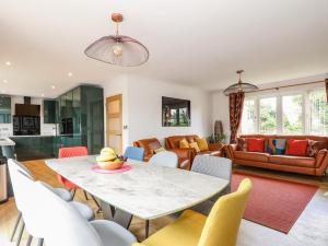 a living room with a table and chairs at Seaview in Lowestoft