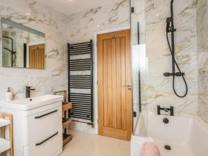 a bathroom with a tub and a sink and a shower at Seaview in Lowestoft