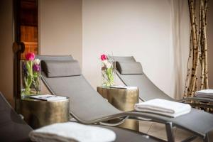 a row of chairs in a waiting room with flowers at Lindner Hotel Dusseldorf Airport, part of JdV by Hyatt in Düsseldorf