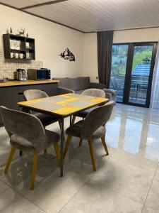 a dining room table and chairs in a kitchen at Prostir 65 in Slavske