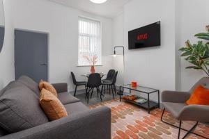 a living room with a couch and a table at Newly Renovated Apartments in Liverpool - Extended Stay in Liverpool