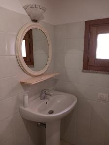 a bathroom with a sink and a mirror at Nora Casa vacanze/bed and breakfast in Pula