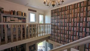 a staircase with a large wall of books at La Maison in Mirebeau-sur-Bèze