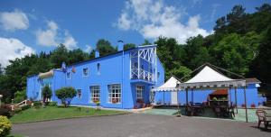 a large blue building with a gazebo at Vega Del Sella in Arriondas