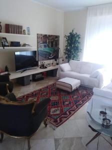 a living room with a white couch and a rug at Angels Home in Livorno
