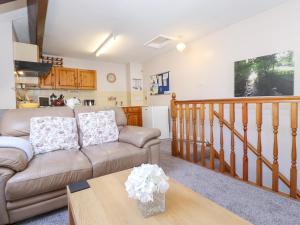 a living room with a couch and a table at Bakers Yard Cottage in Ambleside