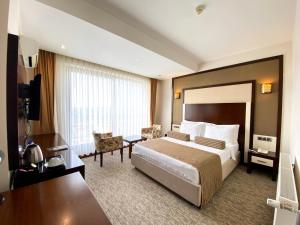 Postel nebo postele na pokoji v ubytování Lavin Hotel & Spa