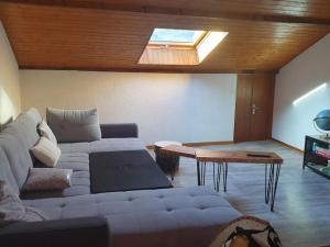 a living room with a couch and a table at Spacieux logement idéalement situé in Saint Avre la Chambre