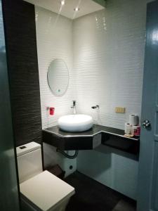 a bathroom with a sink and a toilet at Grand Central Hotel in Angeles