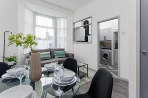 a living room with a table and chairs and a couch at Newly Renovated Apartments in Liverpool - Extended Stay in Liverpool