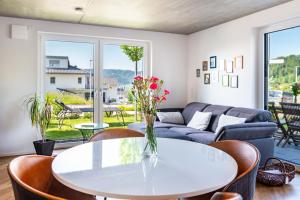 a living room with a table and a couch at Casa Ka Sol in Bodman-Ludwigshafen