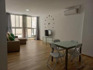 a living room with a table and chairs and a couch at Bazan Apartaments2 in Alicante