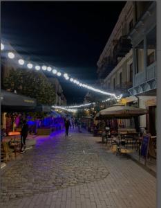 a street at night with lights and tables and chairs at Casa Bonita in Tbilisi City