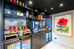 a fast food restaurant with a counter with food at Staycity Aparthotels Paris Gare de l'Est in Paris