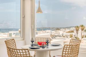 a table in a room with a view of the ocean at Sandy Studio With View In Naousa in Naousa