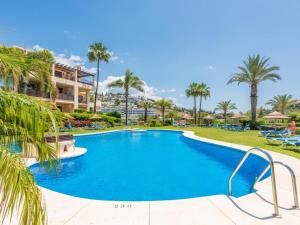 basen w ośrodku z palmami w obiekcie Los Pinos, 3 bedroom apartment in Los Arqueros w mieście Benahavís