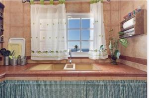 a kitchen with a sink and a window at Casa María - Finca Medina in Alojera