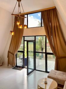 a living room with a large glass window at A Frame Lerik in Lerik