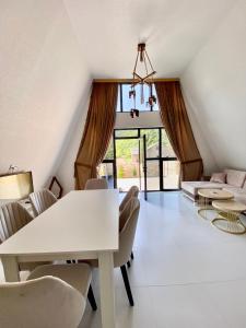 a living room with a white table and chairs at A Frame Lerik in Lerik