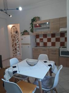 a kitchen with a table and chairs in a room at Evelina 4 in Lixouri