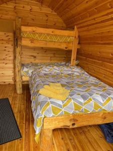 a bedroom with a bed in a log cabin at The Plough and Harrow Tilmanstone in Deal