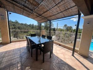a patio with a table and chairs on a balcony at VILLA LE tignet le haut in Le Tignet