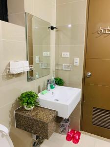 a bathroom with a white sink and a mirror at Studio 8th FL with Balcony across Terminal 3 Airport in Manila