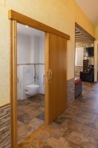 an open door to a bathroom with a toilet at Legaire Etxea in Ibarguren