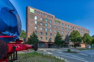 a building with a red fire hydrant in front of it at ibis Styles Hamburg Barmbek in Hamburg