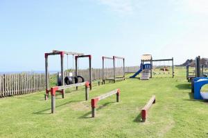 an empty playground with a bunch of swings at Corton Retreats At Waterside Park in Corton