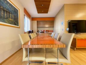 a dining room with a wooden table and chairs at Apartment Felicia 12 in Portorož