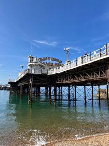 a pier with people on it in the water at Brighton Boutique Garden Studio with Free Parking in Brighton & Hove