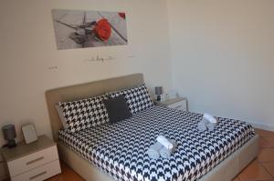 a bedroom with a bed with two stuffed animals on it at Domus Cavour in Civitavecchia