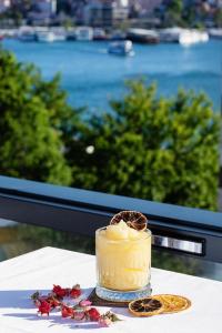 a drink sitting on a table in front of a window at The Halich Hotel Istanbul Karakoy - Special Category in Istanbul