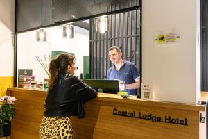 a man standing at a counter with a woman at Central Lodge Hotel in Rome