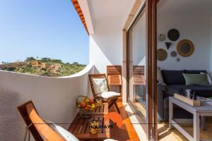 a living room with a couch and a table at #114 Ocean and Marina View with AC in Albufeira