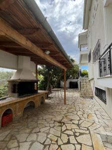 a patio with an outdoor fireplace in a building at A cottage with lemon&orange trees! in Káto Dhiminión