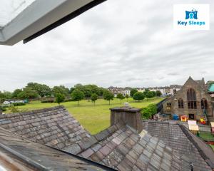 an aerial view of the roof of a church and a field at NEW Four Bedroom House By Keysleeps Short Lets Workington Contractor Leisure Beach Location Lake District in Siddick
