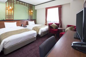 Кровать или кровати в номере Hotel Folkloro Sanrikukamaishi