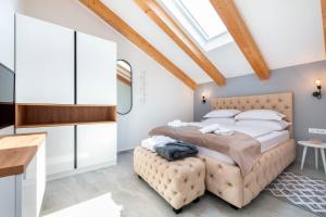 a bedroom with a large bed and a skylight at Boutique Residence Arion in Rovinj