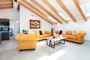 a living room with two couches and a table at Boutique Residence Arion in Rovinj