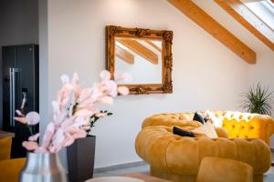 a living room with a couch and a mirror at Boutique Residence Arion in Rovinj