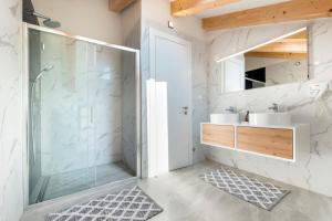 a bathroom with a glass shower and two sinks at Boutique Residence Arion in Rovinj +37 photos