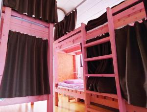 a bedroom with two bunk beds in a room at ゲストハウス 編湊 in Nakaminato