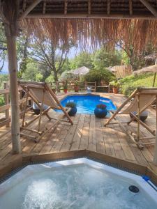 une piscine avec une terrasse et un bain à remous dans l'établissement La lyalis, à Aiguines